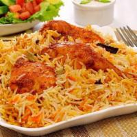 Chicken Biryani · Chunks of tender chicken cooked with flavored basmati rice. Served with our homemade raita.