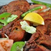 Tandoori Chicken · Pieces of chicken marinated in yogurt with herbs and spices grilled in the clay oven. Served...
