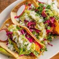 Fish Tacos · Three soft white corn tortillas filled with beer battered fried cod, cabbage, avocado, cilan...