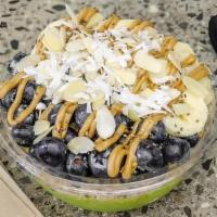 Caveman Bowl · Base includes kale, banana, pineapple, and almond milk. Toppings include granola, banana, bl...