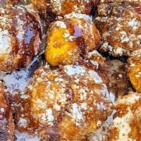 Cheesecake Bites · Deep-fried, battered Cheesecake balls, covered in powdered sugar, topped with chocolate and ...