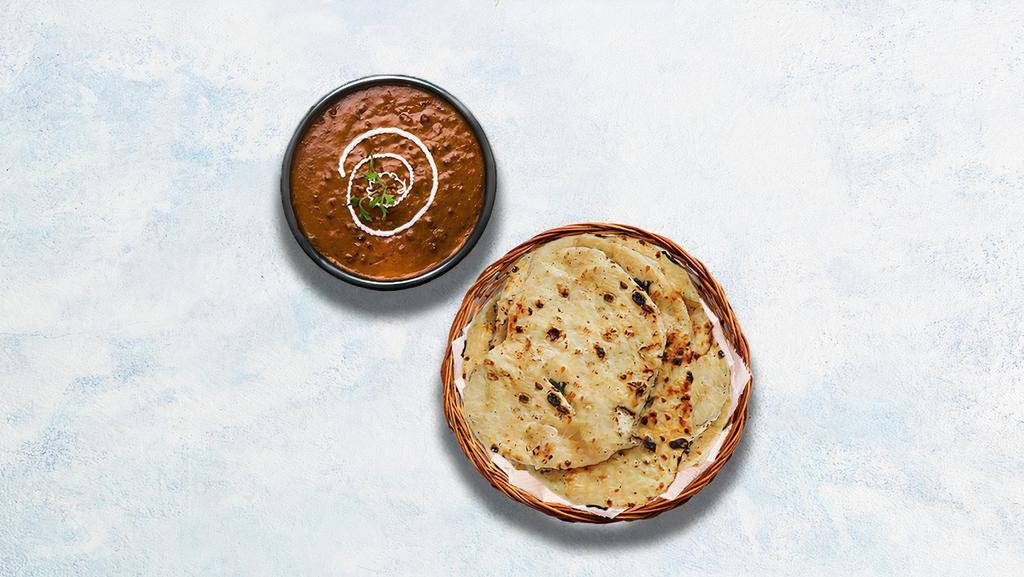Dal Makhani & Butter Naan · Black lentils and red kidney beans slow cooked with herbs, butter, and cream. Served with Indian white flour flatbread baked to perfection in a traditional Indian clay oven and glazed with butter.
