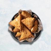 Samosa · Perfectly fried crispy pastry dumplings filled with a mix of aromatic herbs and mashed potat...