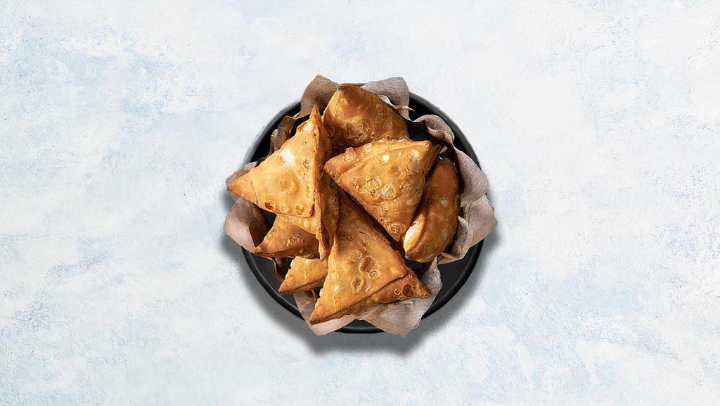 Samosa · Perfectly fried crispy pastry dumplings filled with a mix of aromatic herbs and mashed potatoes.