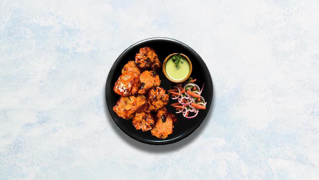 Achari Chicken Tikka · Cubes of cottage cheese marinated in a special blend of yogurt and pickling spices, glazed in a traditional Indian clay oven.