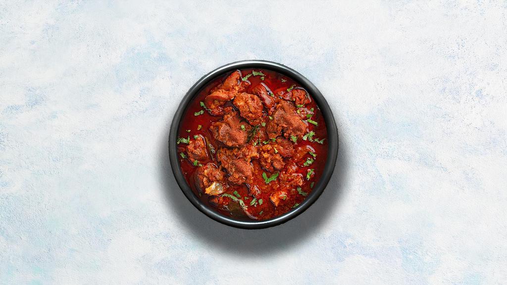 Lamb Vindaloo · Tender lamb morsels marinated in vinegar and garlic cooked to perfection with hot Indian aromatic herbs.