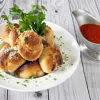 Famous Garlic Knots With Marinara Sauce (6 Pieces) · 6 garlic Knots with 4oz marinara sauce.