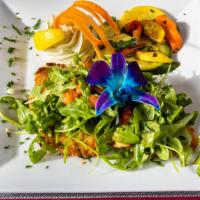Chicken Milanese Over Arugula Salad · Lightly breaded chicken breast over leaves of arugula, served with mixed vegetables and garl...