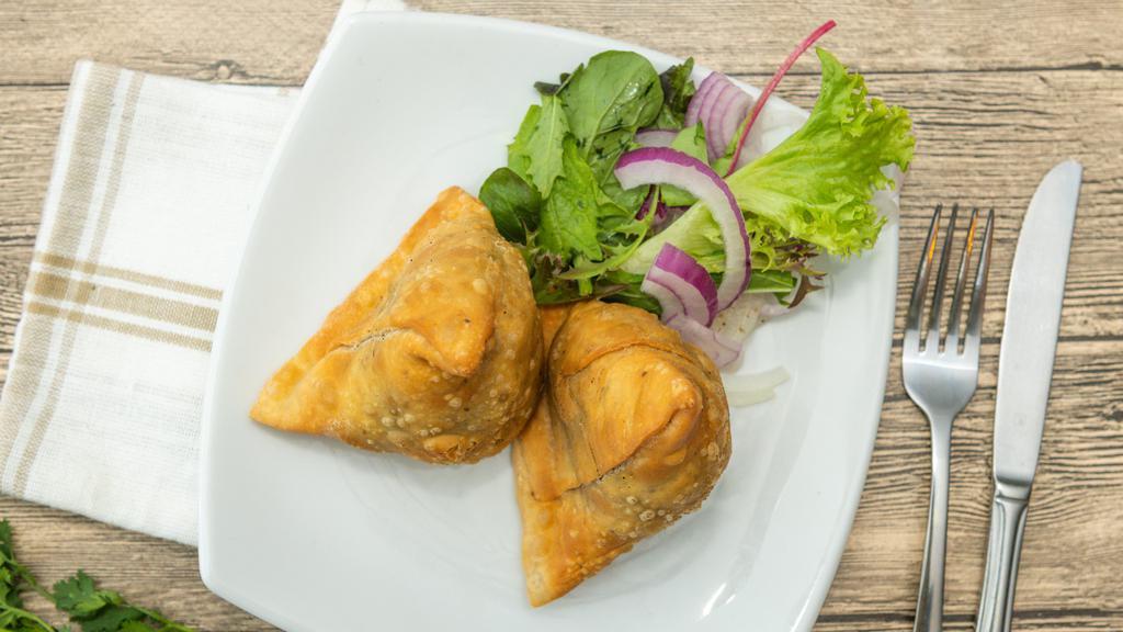 Samosa · Two pieces. Crispy pastry turnover filled with ground chicken or vegetables.