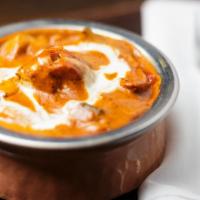 Chicken Tikka Masala · Tender pieces of boneless marinated chicken roasted in a clay oven & cooked in a creamy toma...