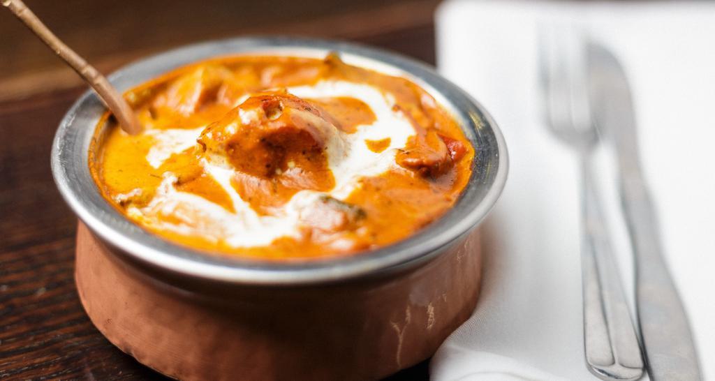 Chicken Tikka Masala · Tender pieces of boneless marinated chicken roasted in a clay oven & cooked in a creamy tomato gravy.