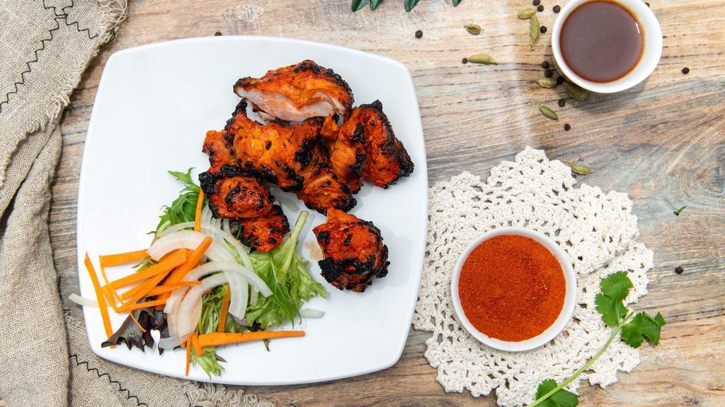 Chicken Tikka · Boneless chicken marinated in herbs and spices, barbecued over charcoal. Cooked with cream and almonds.