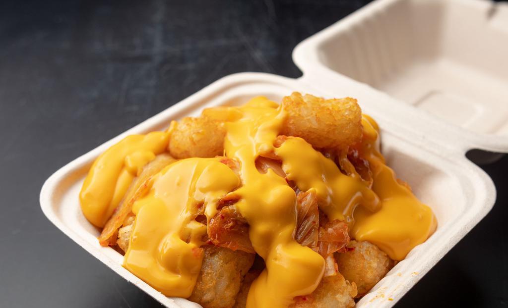 Kimcheese Tots · Tater tots smothered with kimchi and melted cheese. add spicy bacon