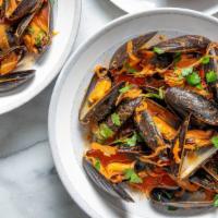 Calabrian Mussels · P.E.I Mussels with fresh tomato, garlic, light spicy white wine sauce.
