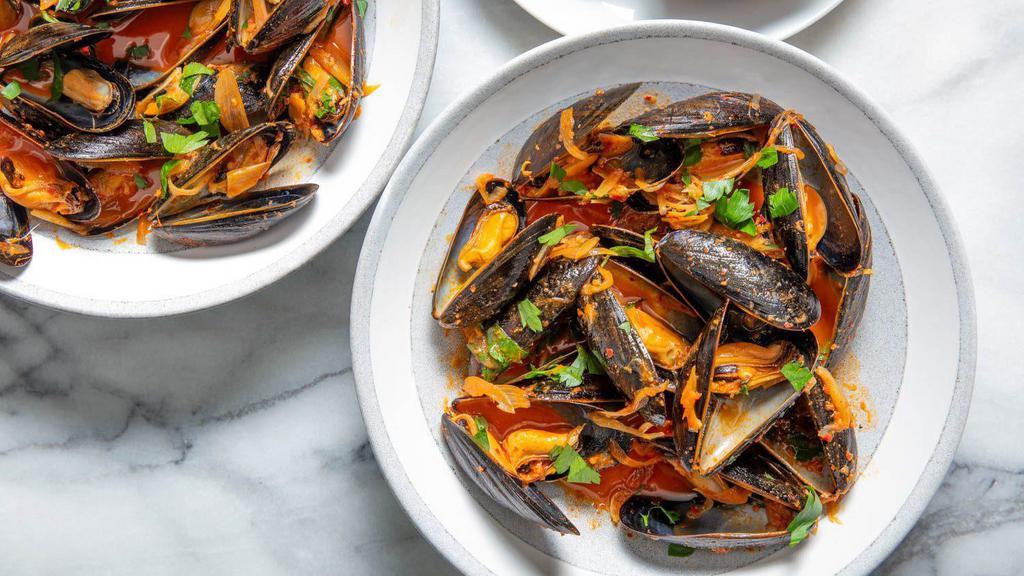 Calabrian Mussels · P.E.I Mussels with fresh tomato, garlic, light spicy white wine sauce.