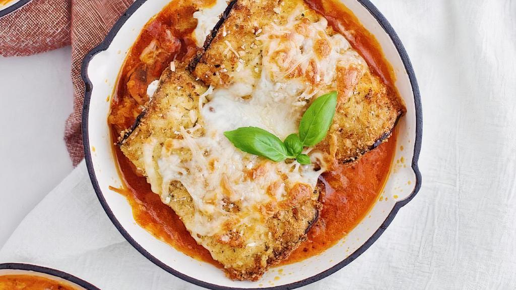 Eggplant Rollatini · Thinly sliced, par-baked eggplant slabs rolled up with a delicious ricotta mixture, baked with red sauce and a little bit of mozzarella cheese.