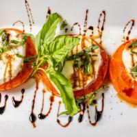 Caprese Salad · Fresh seasonal tomato, fresh mozzarella, arugula, balsamic vinegar and olive oil.