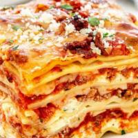 Lasagna · Layered pasta with classic bolognese and bechamel sauce melted mozzarella