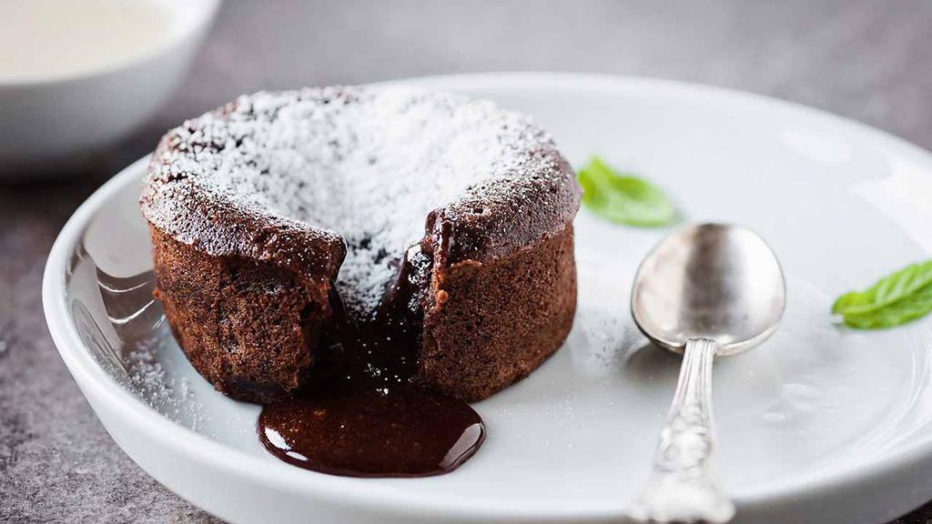Chocolate Souffle · Moist chocolate cake with a heart of creamy rich chocolate served with vanilla ice cream.