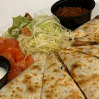 Chicken Quesadillas · Griddled flour tortilla filled with chicken, tomatoes, and cheddar cheese. Served with shred...