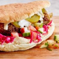 Tradional Falafel Sandwich · Hummus, Pickled Cabbage, Israeli Salad, Beets, Feta Cheese, Tahini.
