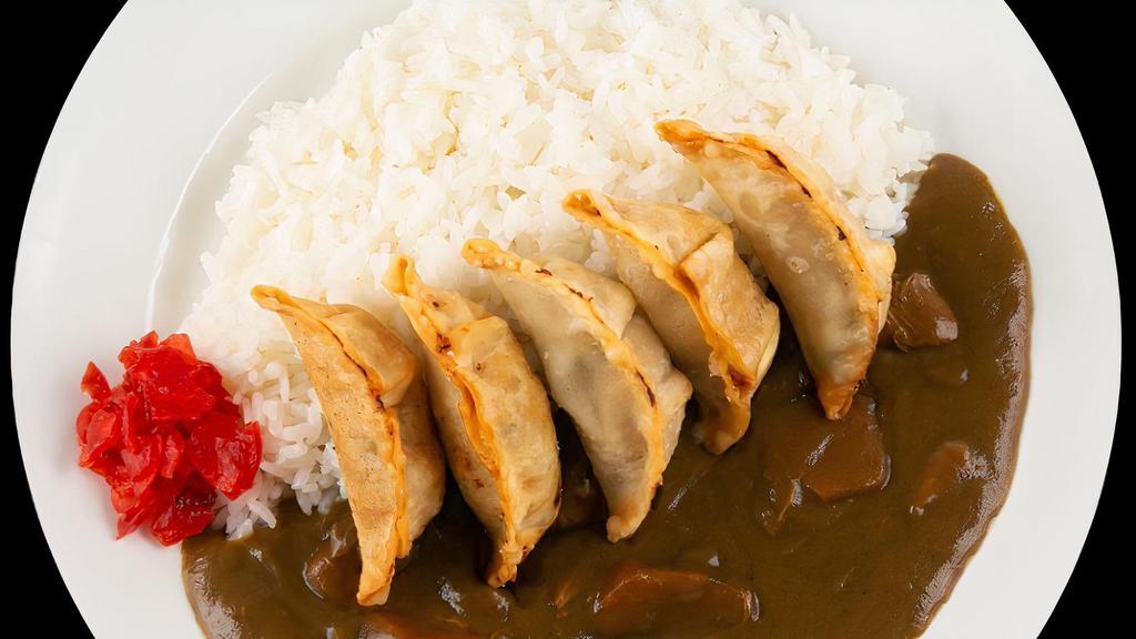 Gyoza Curry Rice · Fried dumplings on steamed white rice topped with our house-made Japanese curry.
