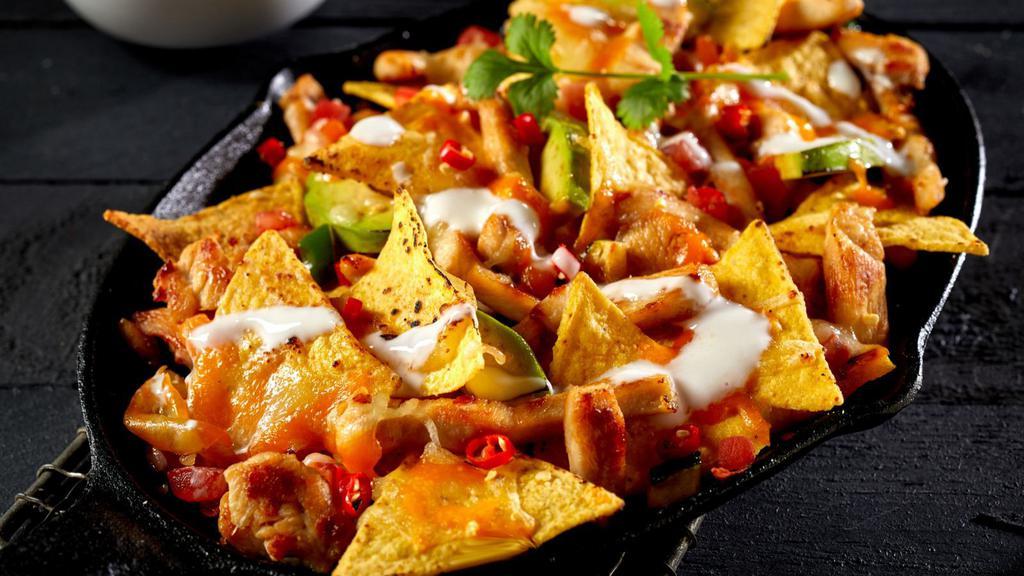 Nachos · Tortilla chips with melted cheese, salsa, and sour cream.
