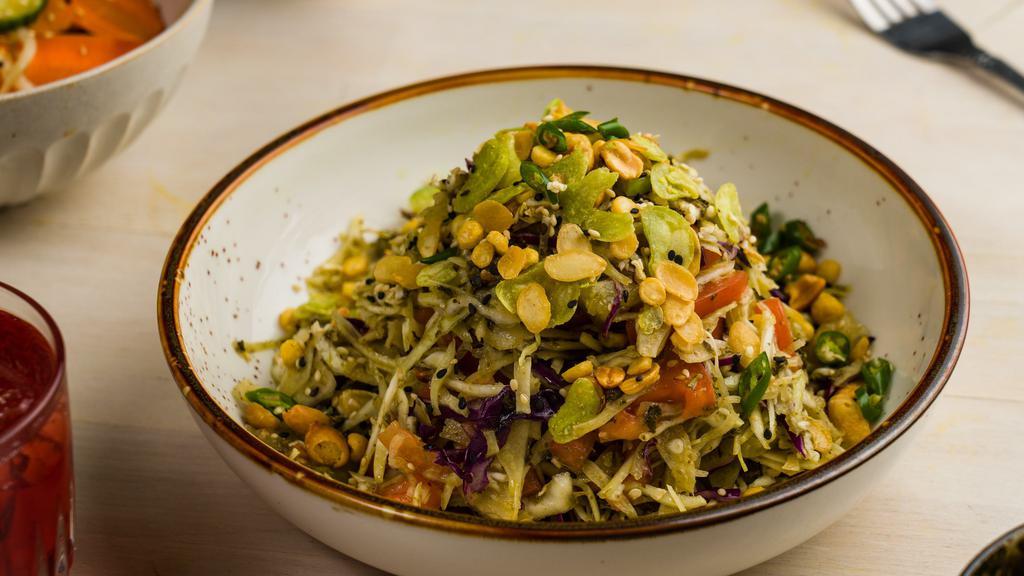 Tea Leaf Salad [V] [Gf] · Fermented Burmese tea leaves with tomato, cabbage, peanuts, fried beans and seeds, lime juice, fresh chili. 

Vegan and gluten free