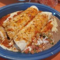 El Burrito Ranchero · Two burritos, soft flour tortilla filled with grilled chicken
and cheese, topped with cheese...