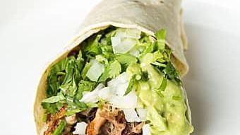 Carnitas(Pork) Taco · Two soft corn tortillas served with guacamole, onions & cilantro.