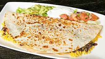 Paquitos Quesadilla · Grilled flour tortilla filled with Monterey Jack cheese, beans, & rice, topped with guacamol...