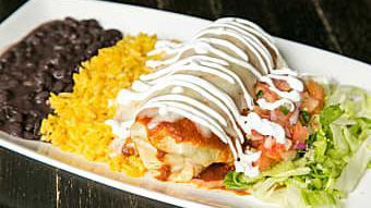 Breakfast Burrito · Flour tortilla filled with scrambled eggs & topped with cheese, chipotle sauce, sour cream; ...