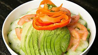 Avocado Salad · Sliced avocado served with lettuce, tomato, cucumber, carrots, and red pepper.