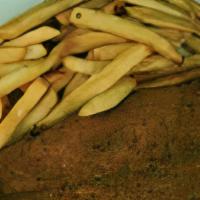 Filete De Pescado Empanizado · Servido con ensalada, arroz y frijoles, papas fritas. / Breaded fried filet of sole served w...