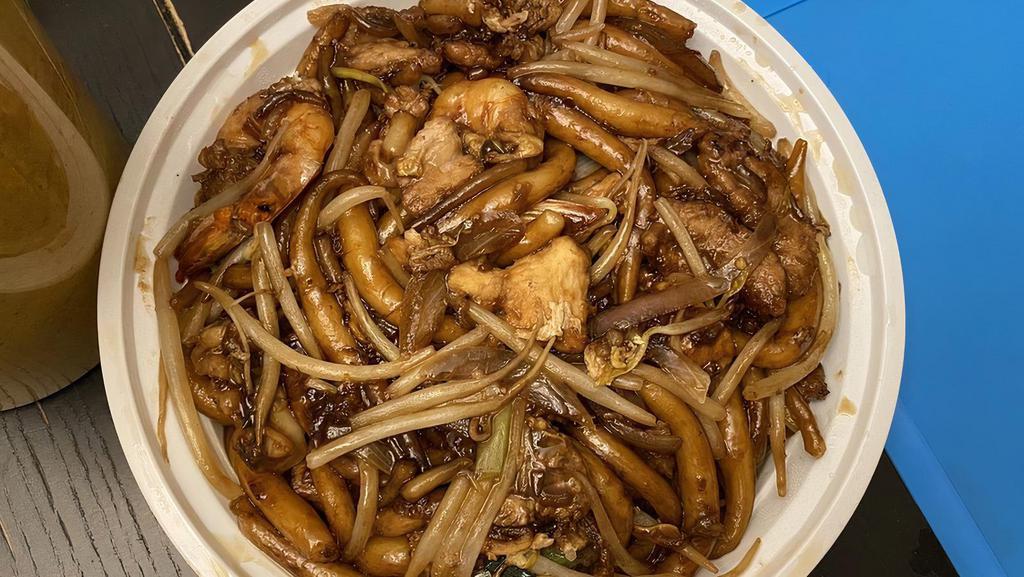 Chow Kueh Teow · Malaysian famous stir fried flat rice noodles with fresh shrimp, pork, squid, bean sprouts, eggs, soy sauce and chili paste. Hot and spicy.