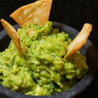Guacamole · Ripped avocado served with tomatoes, lime juice, cilantro, onion and a pinch of salt.