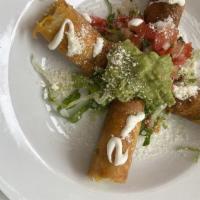 Flautas · 2-corn rolled fried tortillas topped with sour cream and Cotija cheese. Choice: chicken, che...