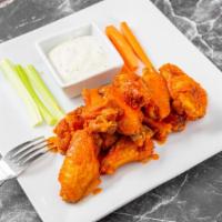 Chicken Wings · Crispy chicken wings accompanied with carrots, celery and ranch dressing. Simmered in your c...