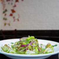 Aguachile  · Our Sinaloa-Seville style jumbo shrimp cooked in a lime juice served with a green pepino sau...