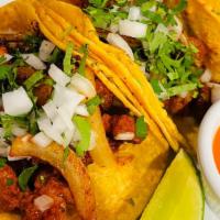 Al Pastor Tacos  · Al pastor is a seasoned and marinated pork, cooked with onions and pineapple.
(3 Tacos)