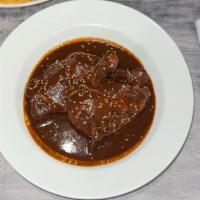 Mole Poblano · An authentic mole sauce with complex flavors from Mexico. This dish blends dried chiles, spi...