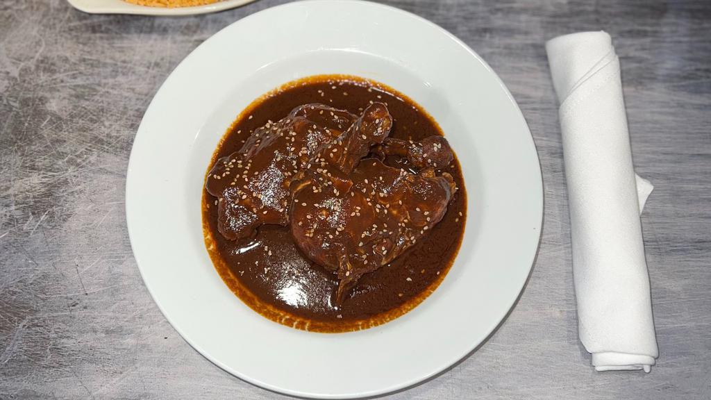 Mole Poblano · An authentic mole sauce with complex flavors from Mexico. This dish blends dried chiles, spices, nuts and seeds into a vibrants sauce full of intricate flavors.