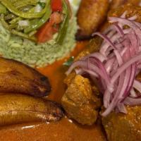 Cochinita Pibil · Marinated pork with a secret sauce recipe. Topped with purple onions. Accompanied with Fried...