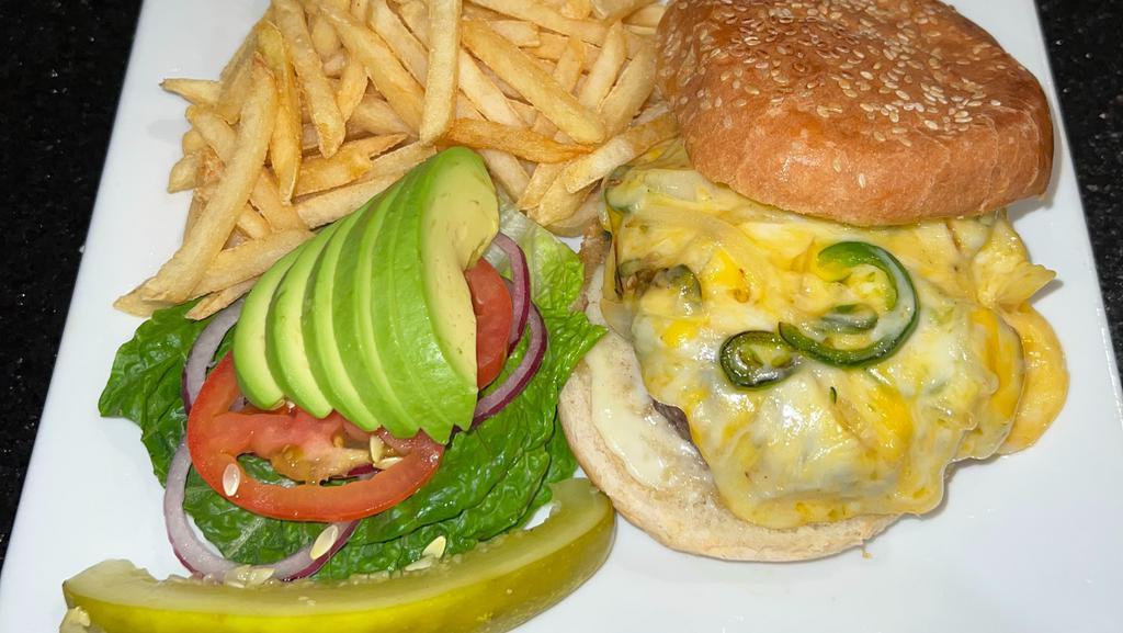 Mexican Burger Deluxe · Sauteed onion, jalapeno, avocado, extra Monterrey & Cheddar melted cheeses. Accompanied with French Fries.