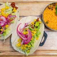 Vegan Tacos · 2 Flour tortilla tacos filled with marinated grilled vegan sausage , topped with lettuce, pi...