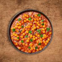 Savory Chickpeas Masala · Chickpeas and diced potatoes cooked in onion and tomato curry with Indian whole spices