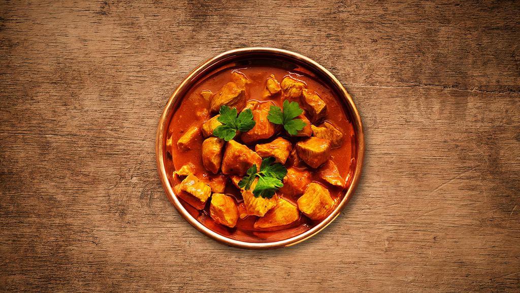 Chicken Tikka Masala · Cubes of tender chicken cooked with onions and bell peppers in tomato and onion sauce served with rice.