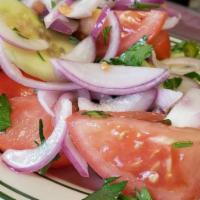 Georgian Salad · vine tomatoes and European cucumbers with fresh purple onion and herbs