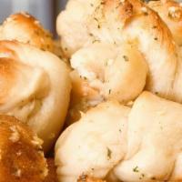 Garlic Knots · Delicious Dough Knots baked and tossed with our Garlic Parm saice served with pizza sauce on...