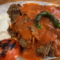 Iskender Kebab · Lamb gyro layer on homemade bread croutons, topped with garlic yogurt sauce. Served with spe...